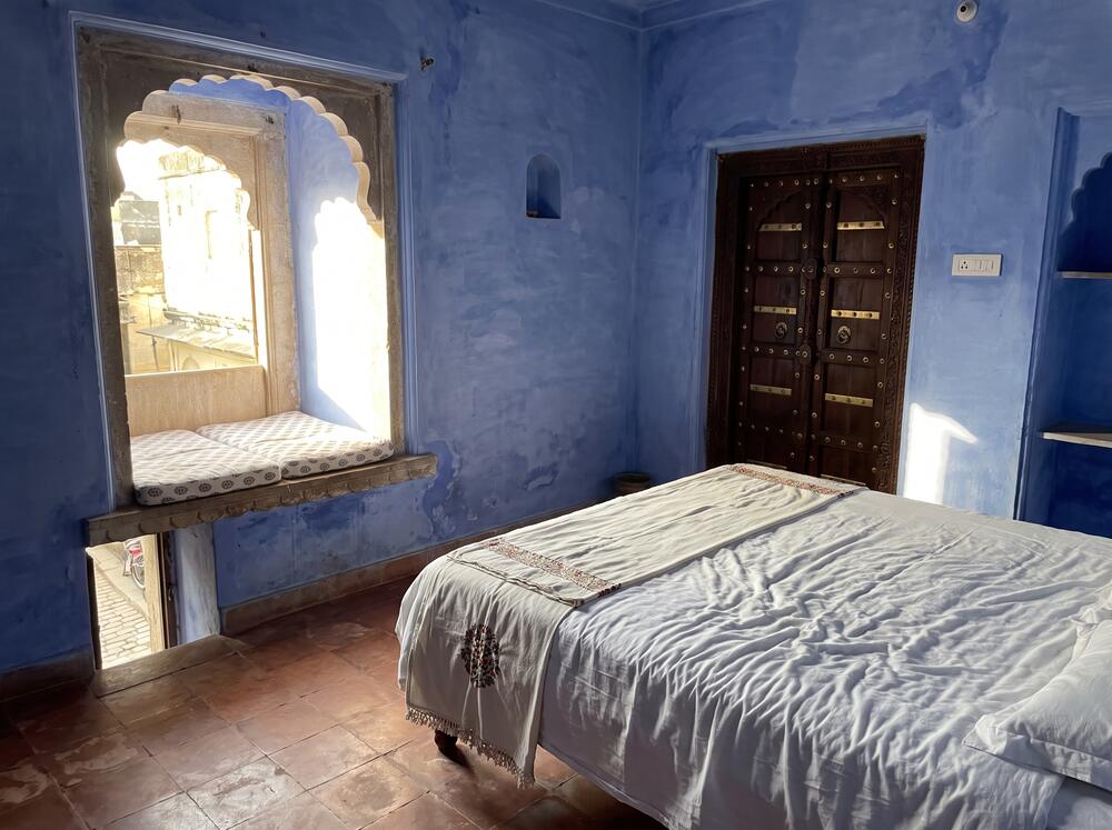 Blue Room, with indigo lime-plaster walls and a deep window seat