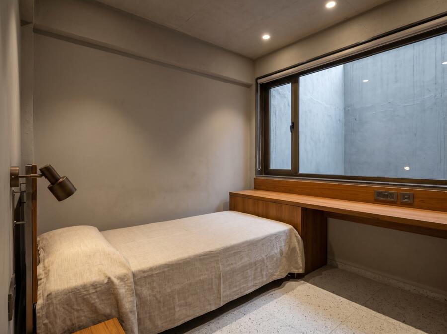 Single room with a full-width teak desk under the window