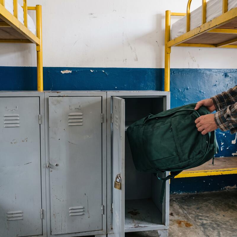 The locker wall in the mixed dorm with a sixty litre backpack going into one